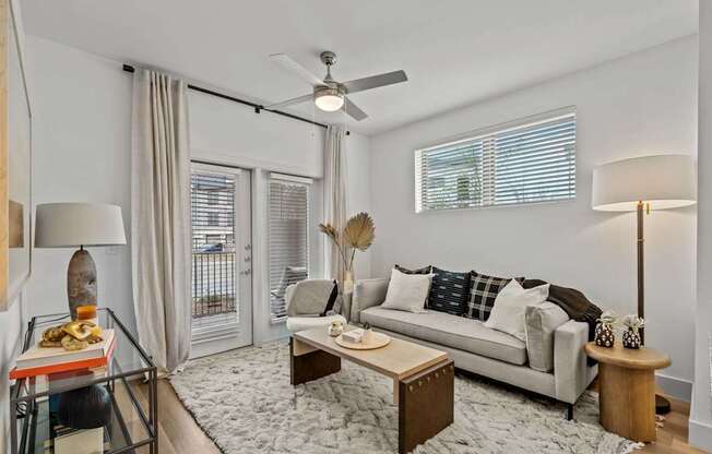 a living room with a couch and a ceiling fan