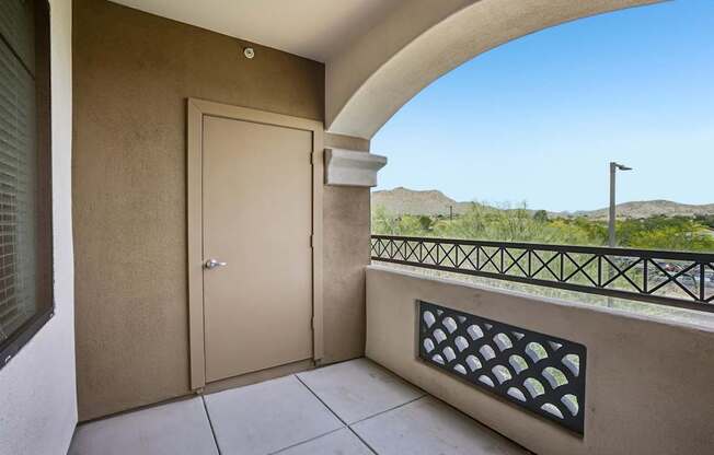 A balcony with a door and a window.