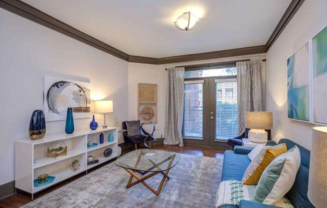 A living room with a blue couch and a wooden coffee table.