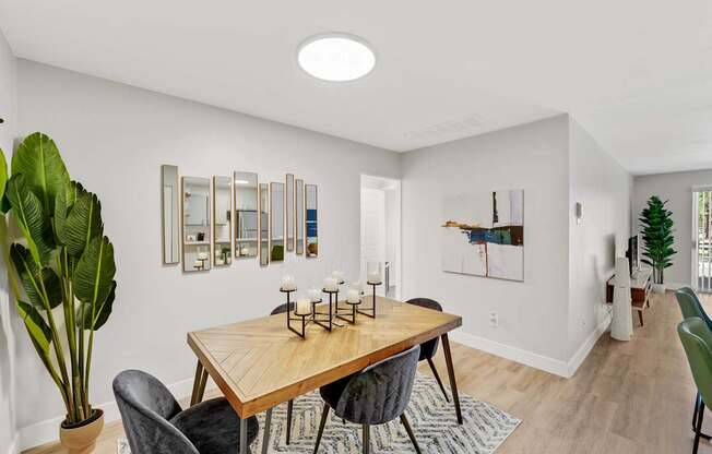 A dining room with a wooden table and chairs.