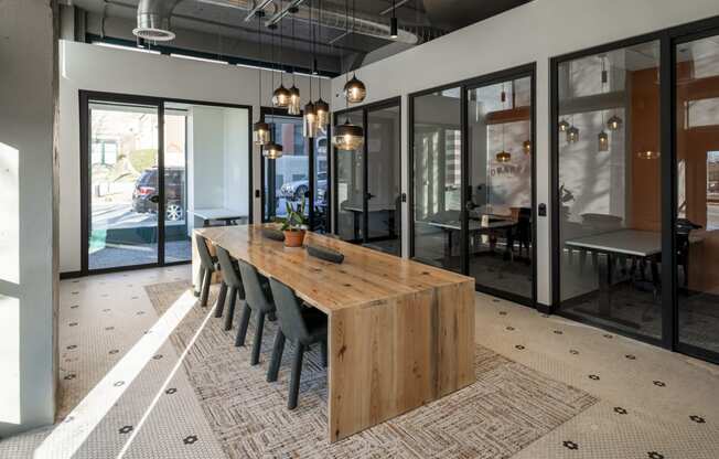 a dining room with a wooden table and chairs at The Draper, St Louis