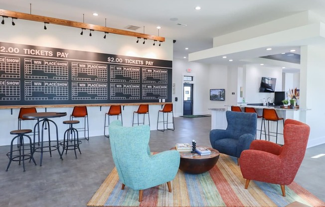 a lobby with chairs and a bar and a large chalkboard