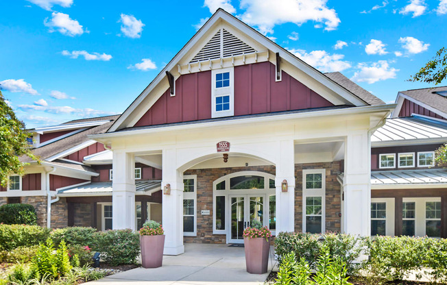 the exterior of a building with a porch and a pathway