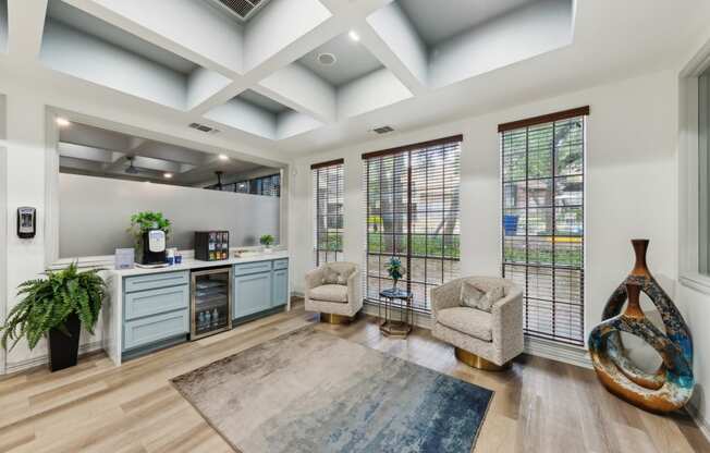 Leasing Office with two chairs and a desk and windows