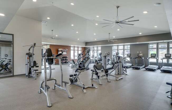 Large fitness center with free weights, weightlifting machines and cardio equipment at Ascend at Woodbury MN 55129 new luxury apartments