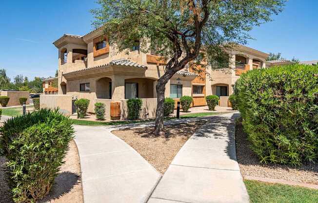 A large house with a tree in front of it.