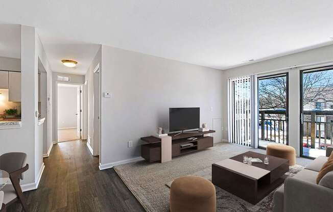 A living room with a television, a couch, and a chair.