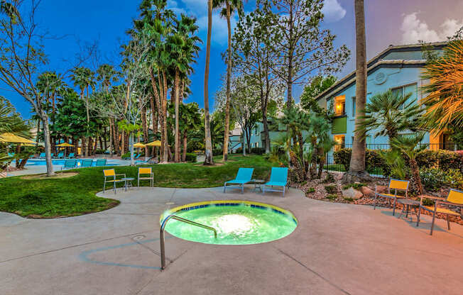 A pool surrounded by palm trees and chairs.