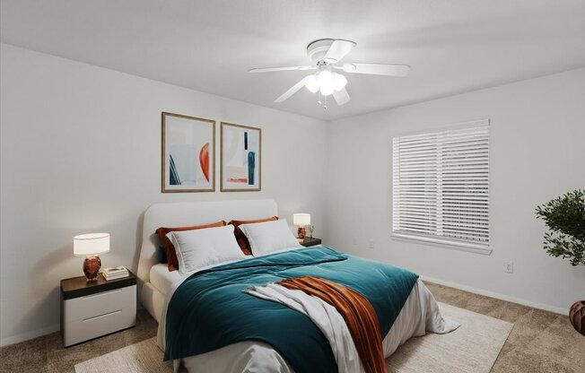 a bedroom with a bed and a ceiling fanat Millcreek Woods Apartments, Olathe, 66061