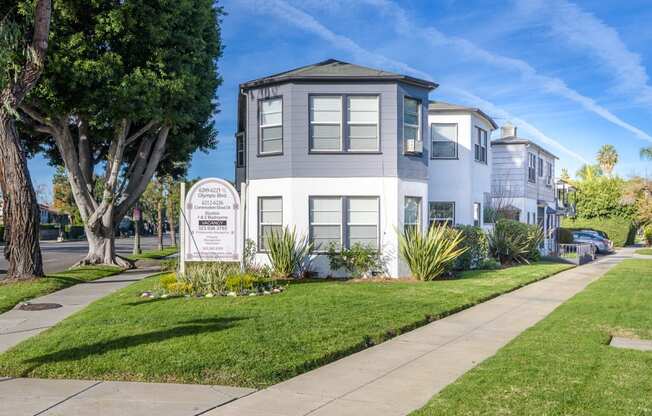 a house with a sidewalk and a sign in front of it