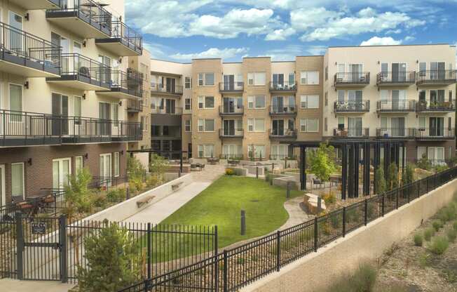 a rendering of an apartment building with a green courtyard