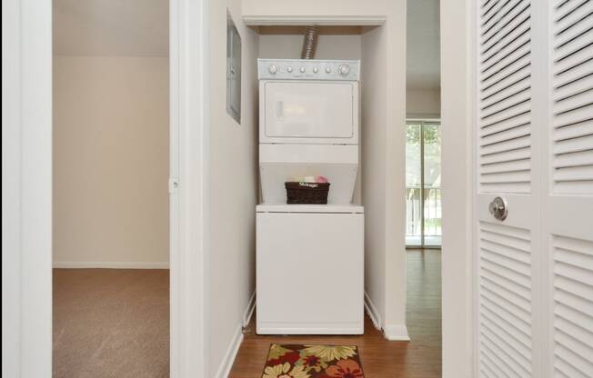 A laundry room with a washer and dryer at Aqua Bay Apartments in Naples, FL 34116