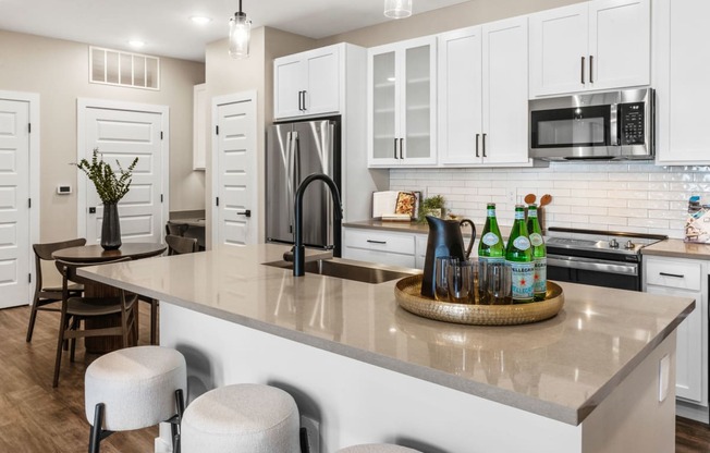 an open kitchen with a large counter with a center island