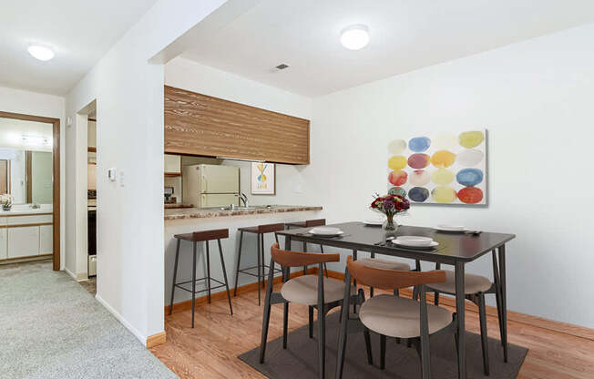 A kitchen and a dining table set for two at Tanglewood Apartments, Oak Creek