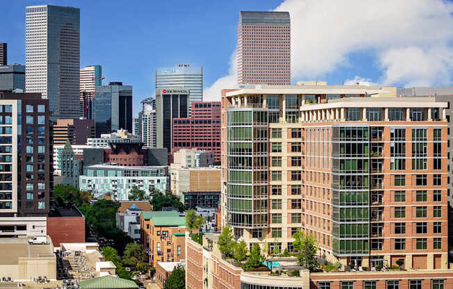 A cityscape with various buildings and a clear sky.