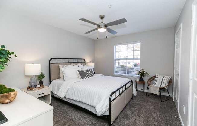 a bedroom with a bed and a ceiling fan