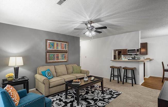 a living room with a couch and a ceiling fan