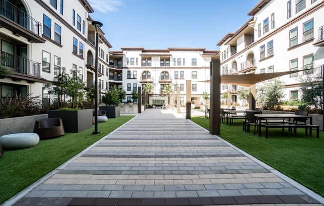 Central Courtyard with BBQs, Fireplace, Outdoor Kitchen and Green Space for Recreation