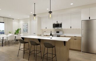 A modern kitchen with a large island and bar stools.