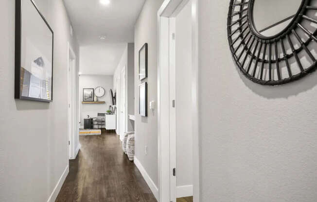 A long hallway with a mirror on the wall.