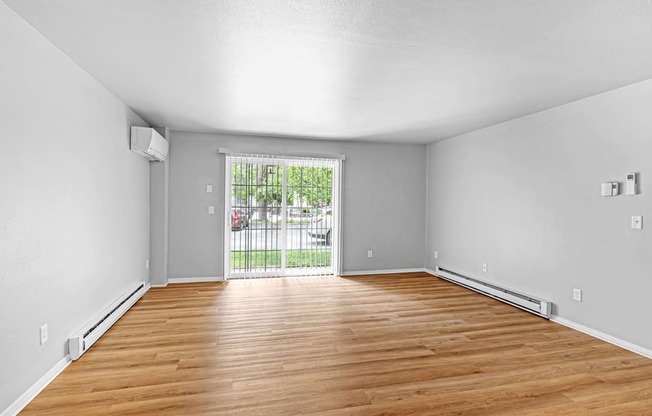 A room with wooden floors and white walls.