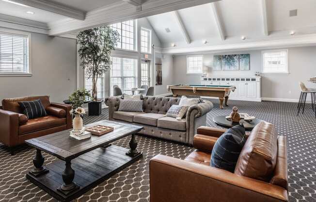 a living room filled with furniture and a pool table