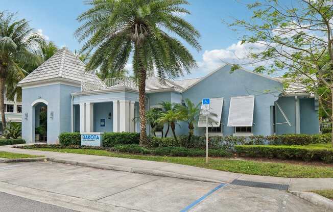A blue building with a sign that says "DAKOTA" in front of it.