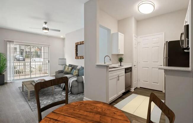 a kitchen and living room with a wooden table