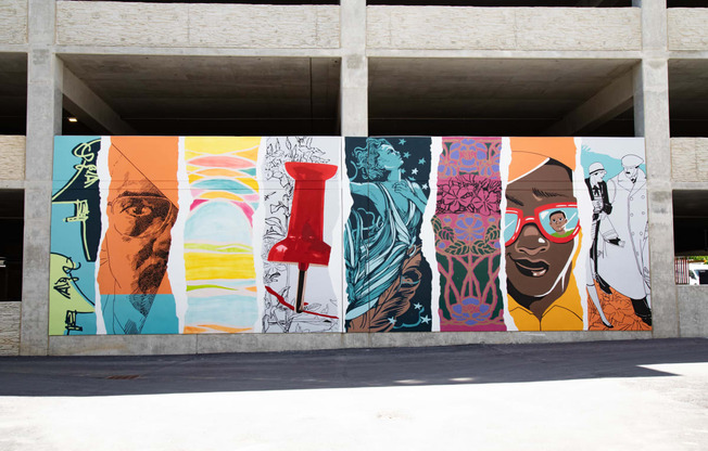 a mural on the side of a building in a parking garage