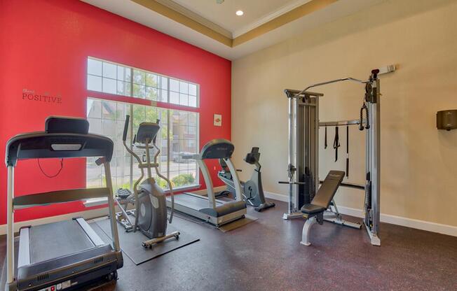 Fitness center with cardio and strength equipment with a big window for natural light