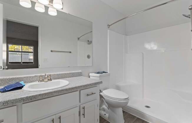 A white bathroom with a sink, toilet, and bathtub.