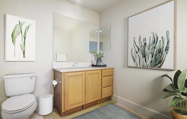 A bathroom with a toilet, sink, and a painting on the wall.