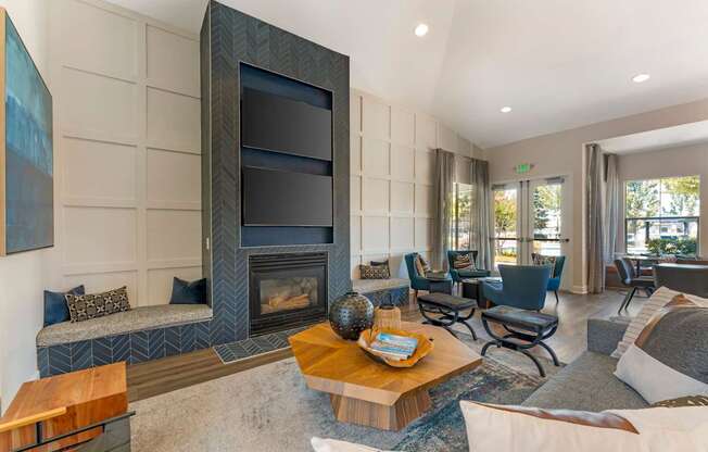 The clubhouse features dual TVs and a cozy fireplace, creating a warm and inviting space for residents to relax and socialize at Ascent at the Galleria.