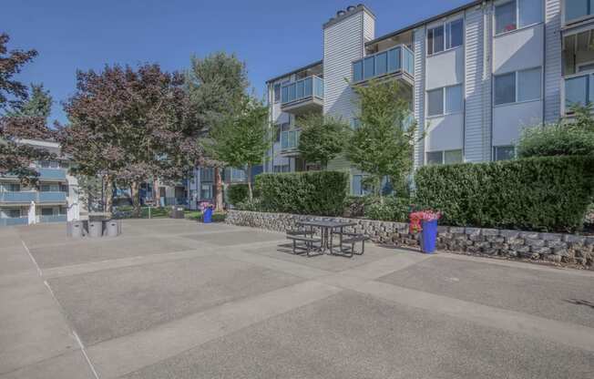 An open area outside of Foster Creek apartment homes with tables and space for outdoor lounging