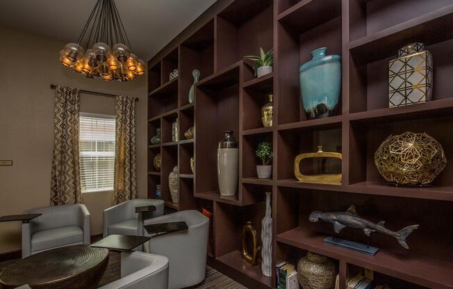 a room filled with furniture and vase of flowers on a table