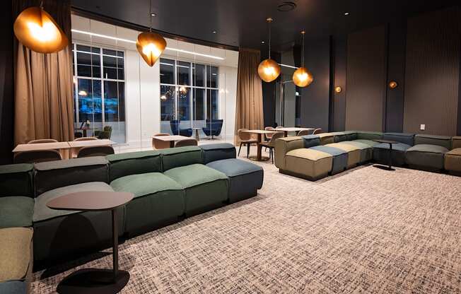 A room with a carpeted floor and a large window with curtains.