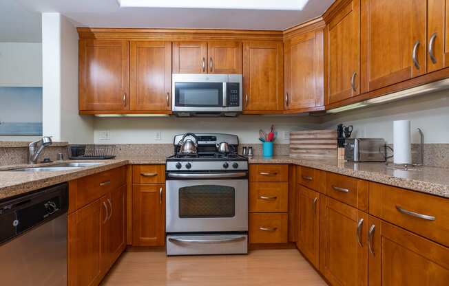 a kitchen with wood cabinets and stainless steel appliances