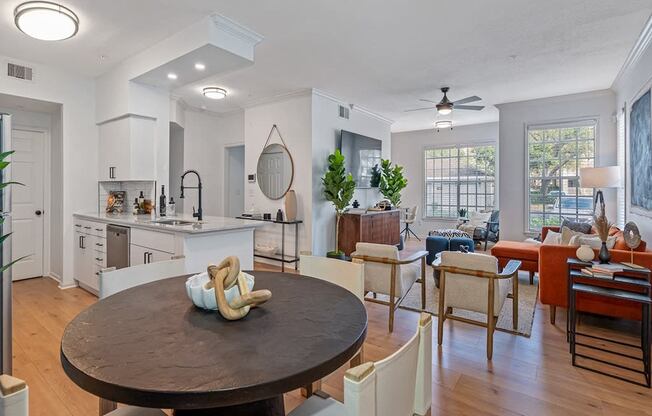 a living room with a dining room table and a kitchen