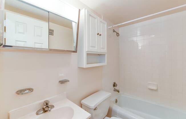 bathroom with toilet, vanity, tub, and medicine cabinet at twin oaks apartments columbia heights washington dc