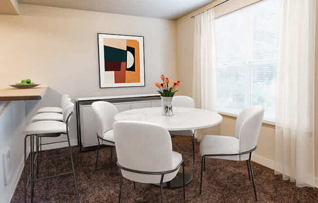 A dining room with a white table and chairs.