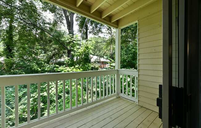 the view from the porch of a cabin in the woods