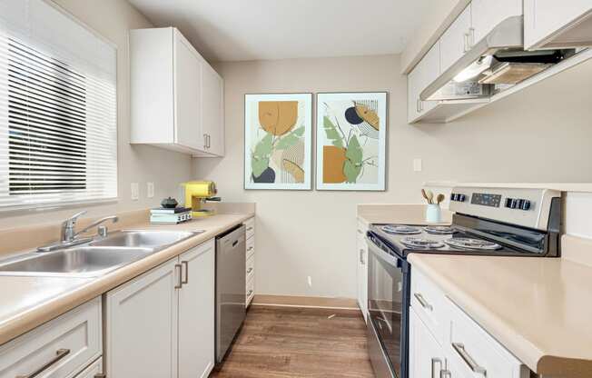 a modern kitchen with white cabinets and stainless steel appliances