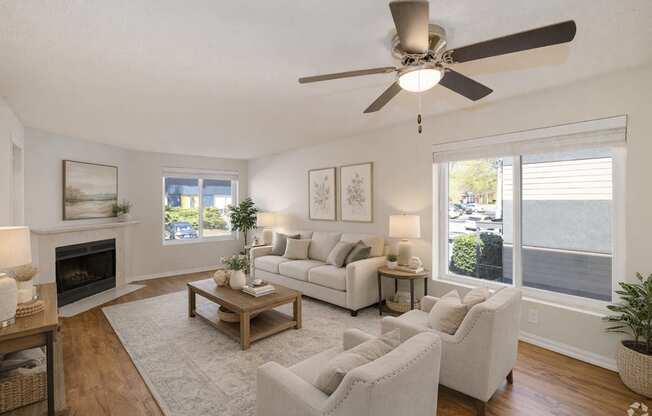 A living room with a fireplace, a white couch, and a ceiling fan.