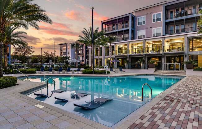 a large swimming pool in front of a building