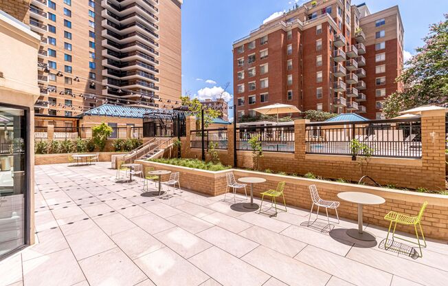 an outdoor patio with tables and chairs