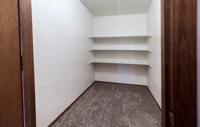 Grand Forks, ND Cherry Creek Apartments. A storage closet in  the unit 223 with shelves