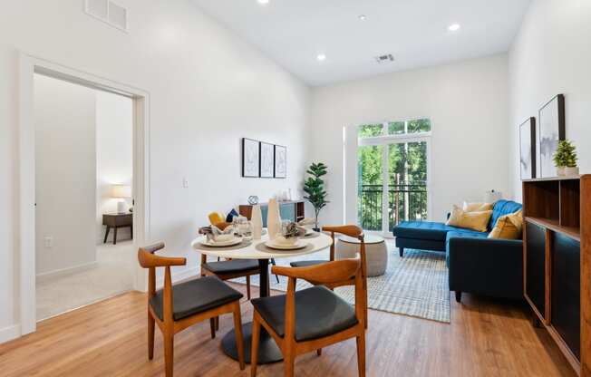 an open living room with a dining room table and chairs