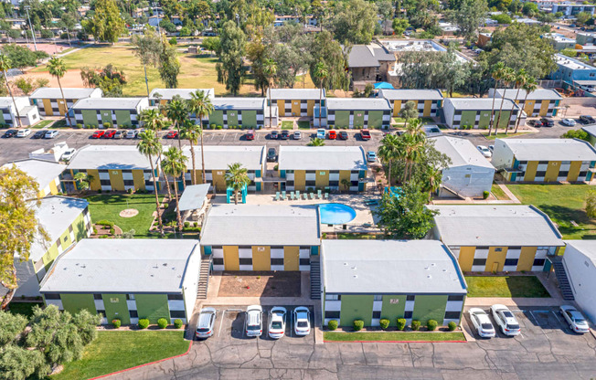 an aerial view of a building with cars parked in a parking lot