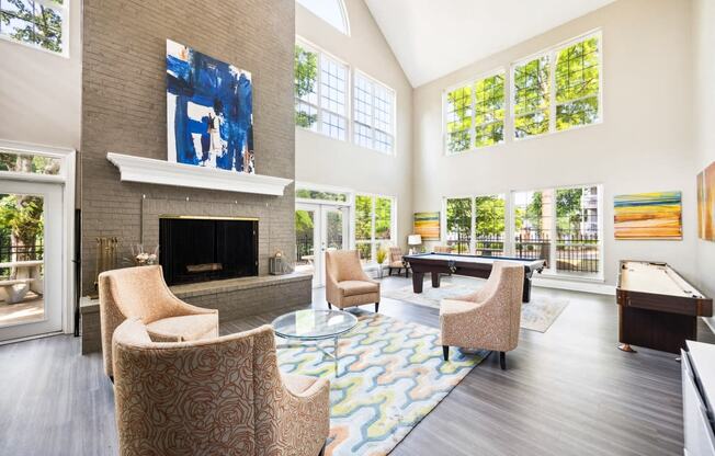 a living room with a large fireplace and a pool table