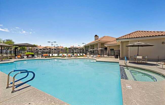 A large outdoor swimming pool with a slide and sun loungers.
